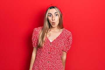 Canvas Print - Beautiful hispanic woman wearing summer dress afraid and shocked with surprise expression, fear and excited face.