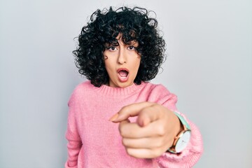 Wall Mural - Young middle east woman wearing casual clothes pointing displeased and frustrated to the camera, angry and furious with you