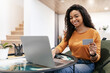 © Prostock-studio - Happy woman holding debit credit card, using computer