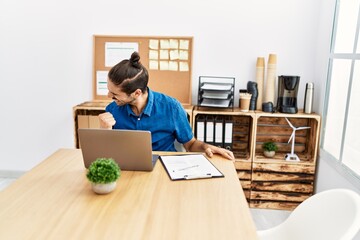 Wall Mural - Handsome hispanic man working with laptop celebrating success at the office