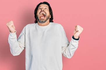 Poster - Middle age caucasian man wearing casual clothes crazy and mad shouting and yelling with aggressive expression and arms raised. frustration concept.