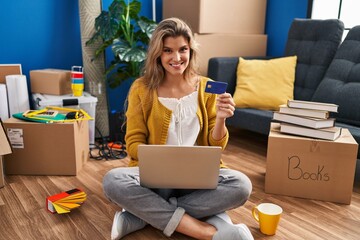 Sticker - Young blonde woman smiling confident using laptop and credit card at new home