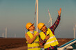 Engineers working on the field at a wind turbine field