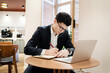 © muse studio - A male businessman is a manager working with a laptop in an office coworking. The lawyer draws up the documents online on the website.