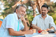 © Pixel-Shot - Senior man with bottle of beer at barbecue party on summer day
