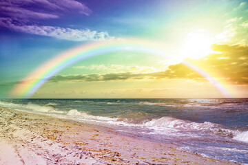 Wall Mural - Beautiful view of colorful rainbow in sky over sea