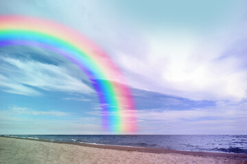 Wall Mural - Beautiful view of colorful rainbow in sky over sea