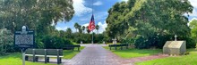 Large American Flag Flying At Half Mast At Veterans Memorial State Park In Vero Beach, Florida.