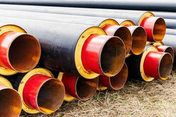 Wall Mural - Insulated pipe. Large metal pipes with a plastic sheath at a construction site. Modern pipeline for supplying hot water and heating to a residential area.