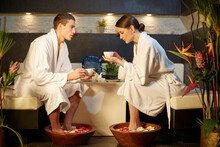 Boy And Girl Drinking Tea In A Spa Salon