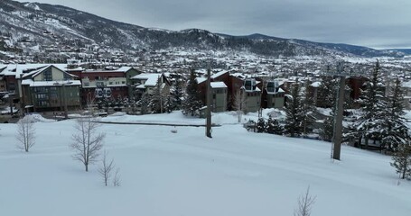 Sticker - Breathtaking bird's eye view of snow-covered village with mountains on the background