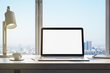 Poster - workplace in office interior with blank mock up laptop computer screen, window with beautiful city view, coffee cup and other items on desktop, pieces of furniture and daylight. 3D Rendering.