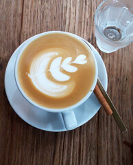 hot coffee in white cup placed on wooden table