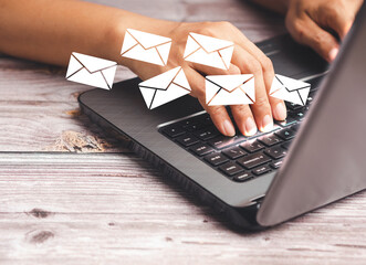 Businessman receives a new message with email icons on a virtual screen while sitting in the office