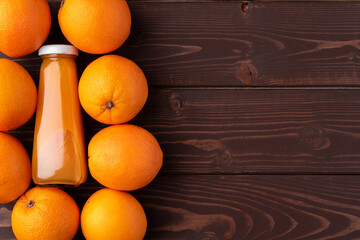 Wall Mural - Fresh orange juice in the glass with orange fruit on wooden background