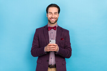 Sticker - Photo of young cheerful man use mobile speed connection button subscribe isolated over blue color background