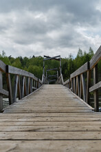 Kaluga Region, Nikola Lenivets Art Park, Ugra National Park. Nature Of Russia And Architecture. Beautiful Symmetrical Wooden Bridge Over River Or Swamp, Without People Foreshortening From Below.