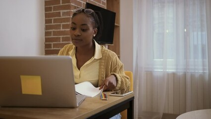 Wall Mural - Young African American woman learning from her living room.