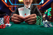 Gambling concept. Close up of Poker Player male hand Winning Royal Flush at casino, gambling club. Сasino chips or Casino tokens,  dice, poker cards, gambling man lucky guy, games of chance