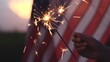 Happy 4th of July Independence Day, Hand holding Sparkler fireworks USA celebration with American flag background. Concept of Fourth of July, Independence Day, Fireworks, Sparkler, Memorial, Veterans