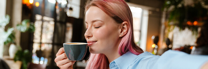 Wall Mural - Young woman taking selfie photo while drinking coffee in cafe