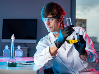 Poster - male chemist with a flask in his hand. scientific research in the chemical laboratory. discoveries i