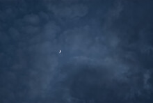 The Moon Peeking Through Clouds