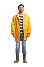 Full Length Portrait Of A Man In A Yellow Raincoat And Rubber Boots