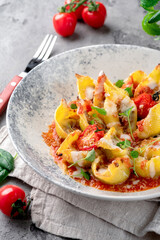 Wall Mural - Pasta Conciglioni with bolognese sauce, tomatoes, parsley and parmesan. Original Italian pasta dish baked on a plate