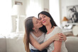 © olly - daughter kisses her mother on the cheek