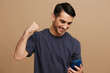 © SHOTPRIME STUDIO - man smartphone posing fashion self-confidence beige background