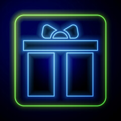 Wall Mural - Glowing neon Gift box icon isolated on blue background. Happy Birthday. Vector