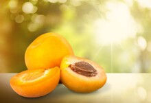 Orange Fresh Ripe Apricots With Leaves On A Wooden Table