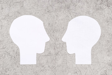 Human communication concept with two paper human heads