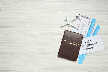 Wall Mural - Passport, toy plane and tickets on white wooden background, flat lay with space for text. Visa receiving