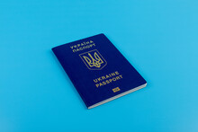 Ukrainian Passport With A Golden Trident Symbol On Blue Background. Biometric Ukraine Passport Id Empty Place For Photo Or Text.