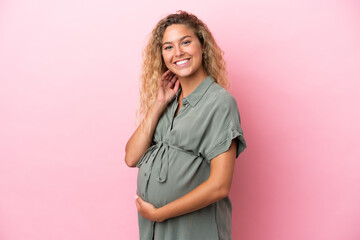 Wall Mural - Girl with curly hair isolated on pink background pregnant and happy