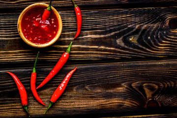 Wall Mural - Cooking hot food with chilli pepper on wooden table background top view copy space