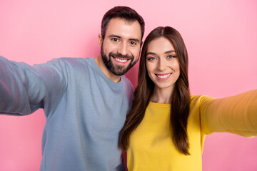 Portrait of two positive nice partners make selfie record video toothy smile isolated on pink color background