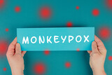 Fototapeta Kawa jest smaczna - The word monkeypox is standing on a paper, outbreak of the MPXV virus, infectious disease spreading