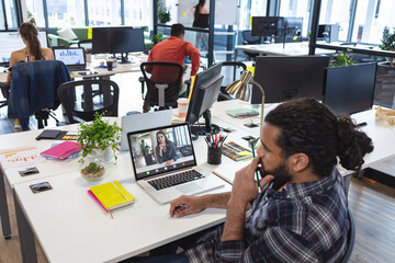 Poster - African american businessman planning strategies with female colleague on laptop in office