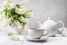 Useful Spring Tea With Bird Cherry In A White Cup On A Light Background