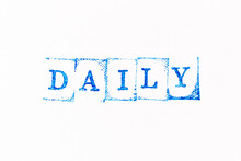 Blue Color Ink Rubber Stamp In Word Daily On White Paper Background