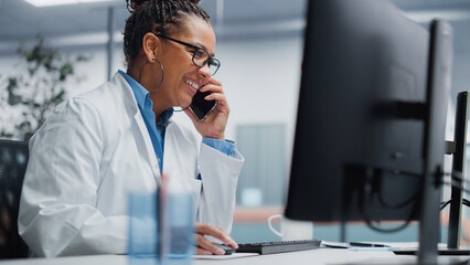 Wall Mural - Medical Hospital Research Lab: Black Female Neurosurgeon Using Computer with Brain Scan MRI Images, Talking on the Phone with Sick Patient. Health Care Neurologist Finding Treatment. Energetic Arc