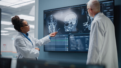 Medical Neuroscience Hospital Lab Meeting: Diverse Team of Neurosurgeon and Neurologist Analyze TV Screen Showing MRI Scan with Brain Images, Talk About Sick Patient Treatment Method, New Drugs Cure