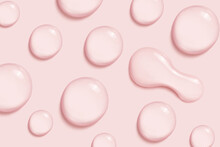 Drops Of Cosmetic Liquid On Pink Background.