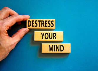 Destress your mind symbol. Concept words Destress your mind on wooden blocks. Doctor hand. Beautiful blue table blue background. Psychological business and destress your mind concept. Copy space.