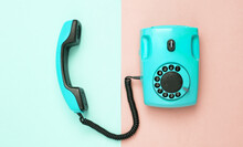Retro Blue Old Fashioned Rotary Phone On Pink Blue Background. Top View
