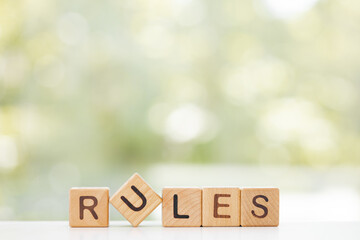 The word rules on wooden cubes.