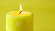 Yellow Color Candles Slowly Burning Down.